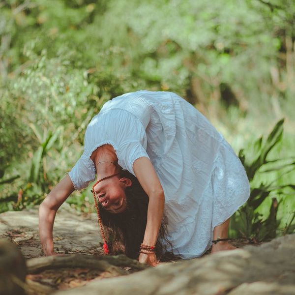Person performing a gentle stretching exercise in a calm environment.